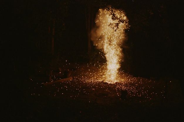 Film still from BURNING FIRE: A campfire at night.