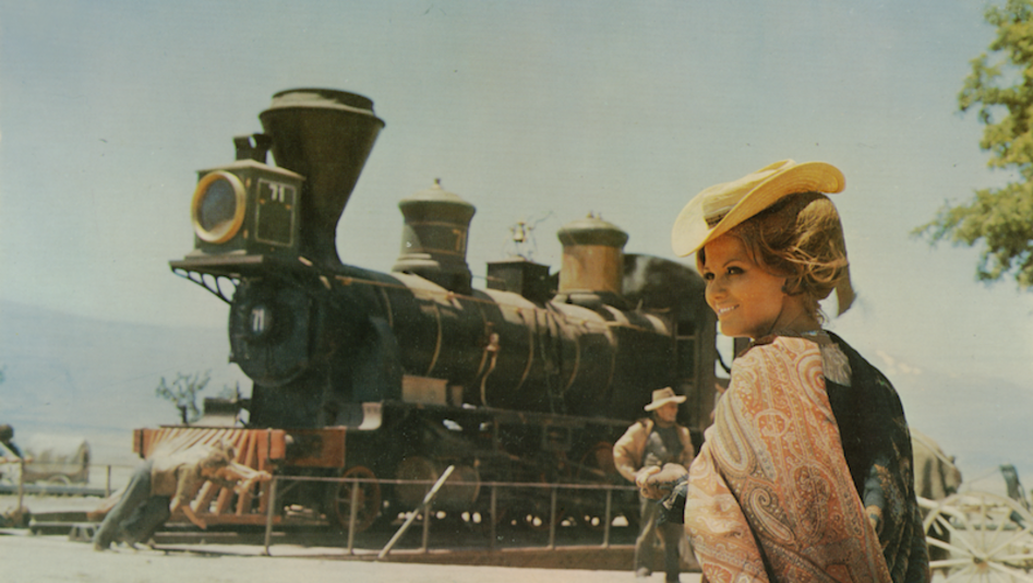 Film still from C'ERA UNA VOLTA IL WEST: A woman walks towards a train.