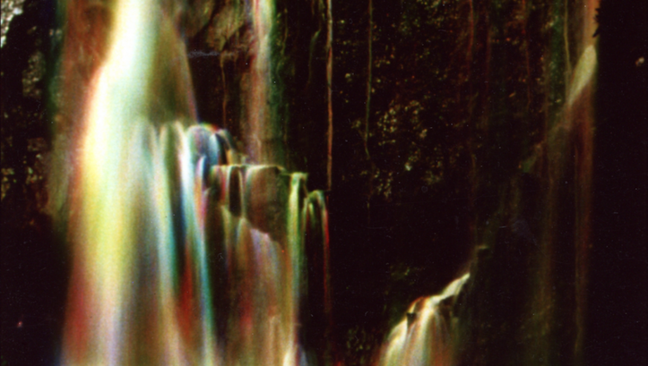 Film still from WATERFALL: A waterfall that sparkles in various colors.