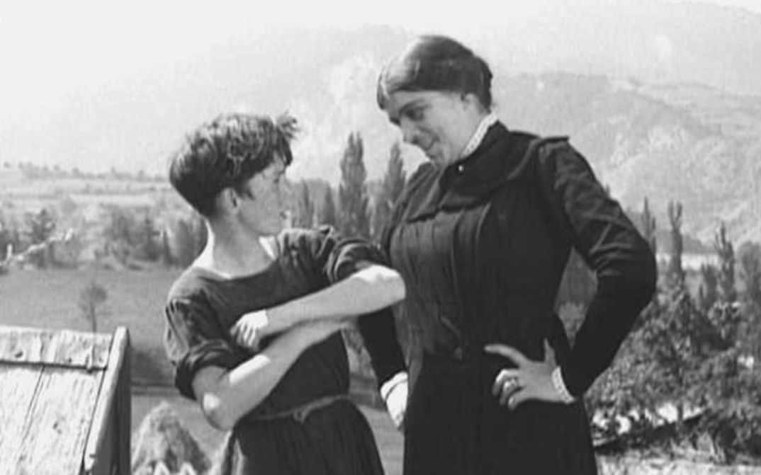 Film still from POIL DE CAROTTE: A woman scolds a boy.