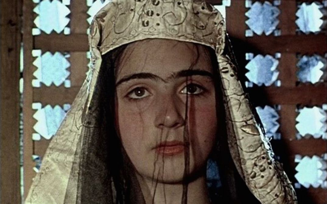 Film still from ASHIK KERIB: A young woman with an elaborate headdress.