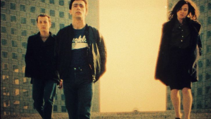 Film still from PETIT VOYAGE: Three young people between skyscrapers.