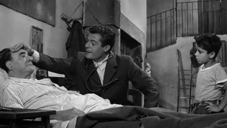 Film still from IL MEDICO E LO STREGONE: Marcello Mastroianni as a doctor visiting a patient.
