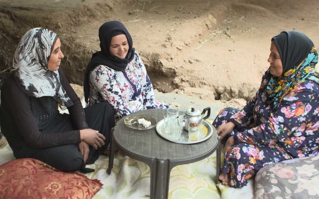 Film still from SUSPENDED WIVES. Three women are sitting at a low table.