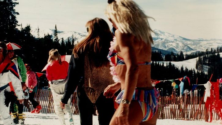Film still from ASPEN. A group of skiers, one of them in a bikini.