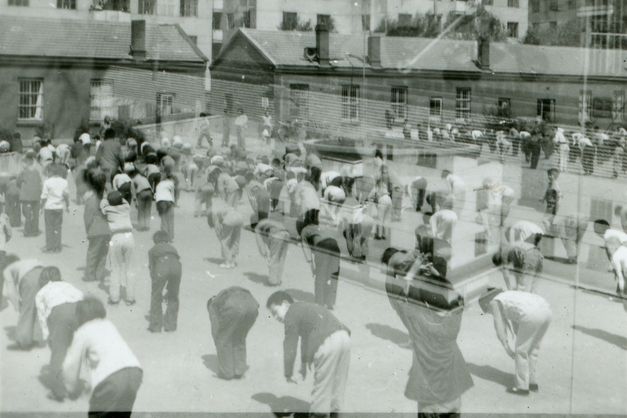 Two black and white images, you can people of different age groups on a public square practising gymnastics.