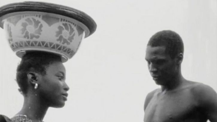 Film still from "Kaddu Beykat" by Safi Faye. It shows a black and white photograph of a woman