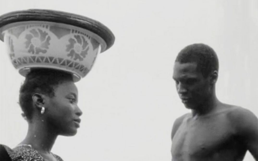 Film still from "Kaddu Beykat" by Safi Faye. It shows a black and white photograph of a woman