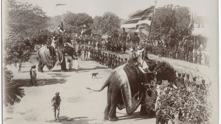 Film still from DELHI DURBAR, 1903: A procession with two richly decorated elephants.