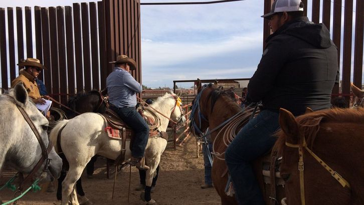 Film still from CROSSING COLUMBUS: Men in cowboy hats on horses.