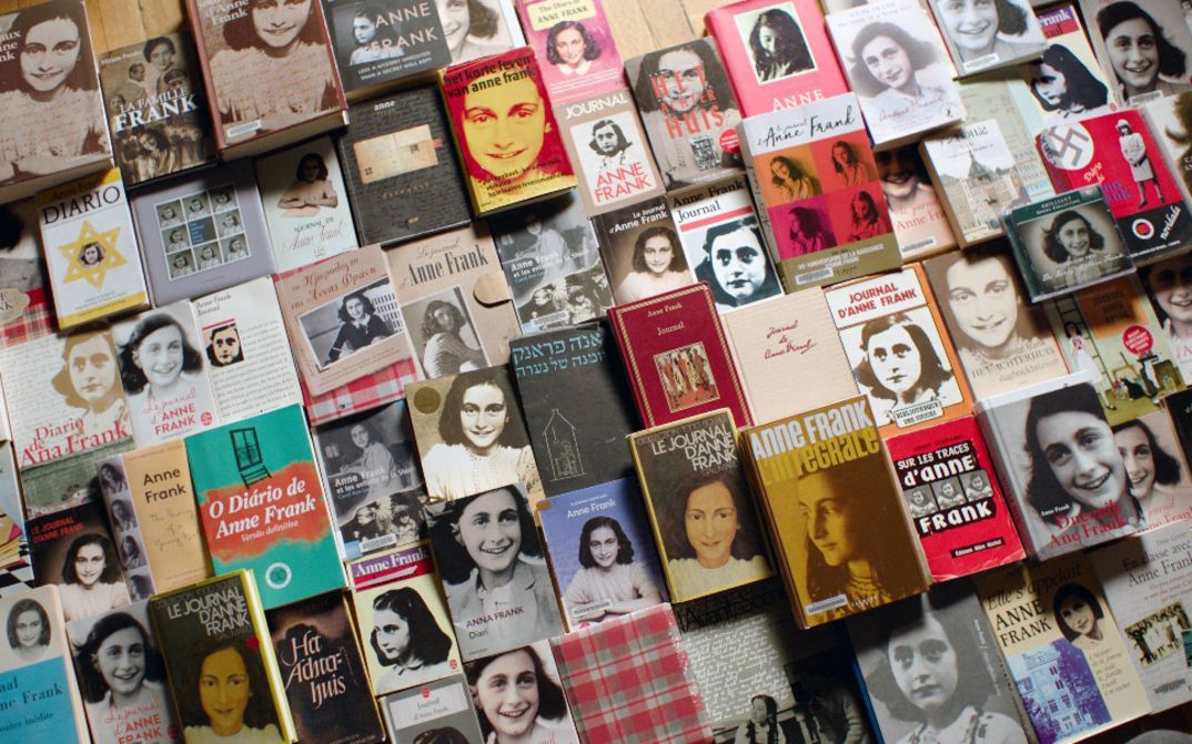 Many editions of “The Diary of Anne Frank” in different languages arranged side by side.