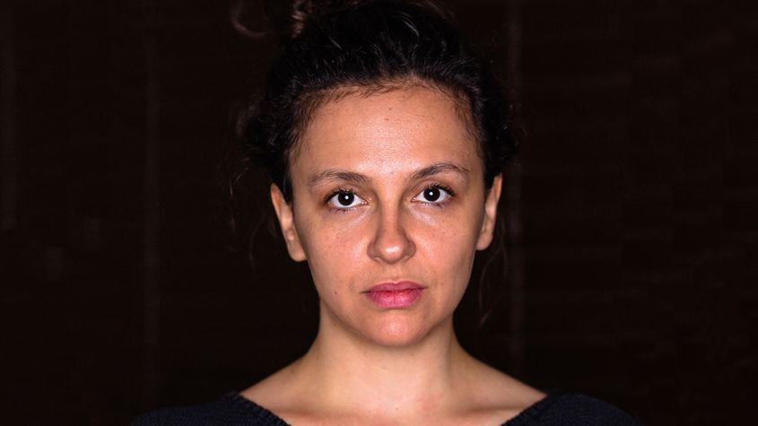 Portrait of Jasmina Metwaly against a black background.
