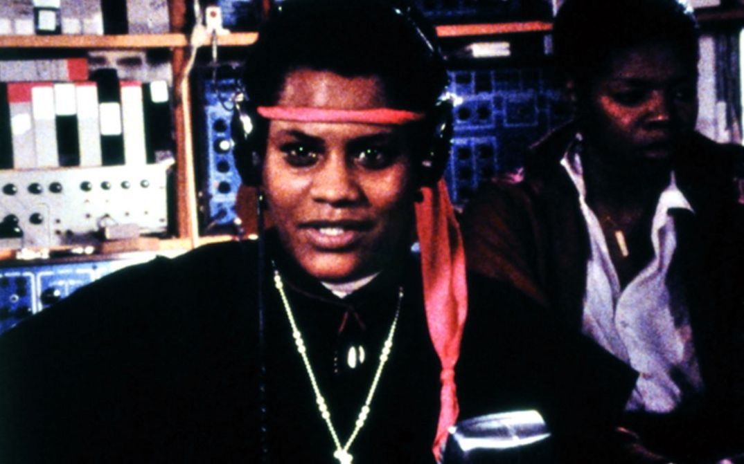 Film still from BORN IN FLAMES. Two women in a radio studio.