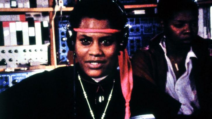 Film still from BORN IN FLAMES. Two women in a radio studio.