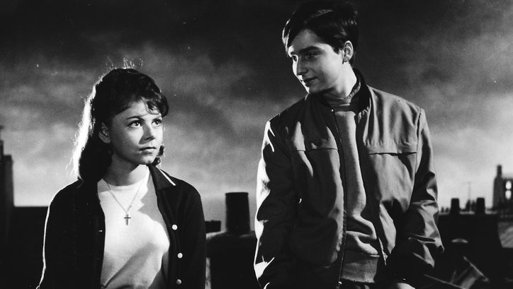Film still from BOULEVARD: Two young people standing on a roof in Paris.