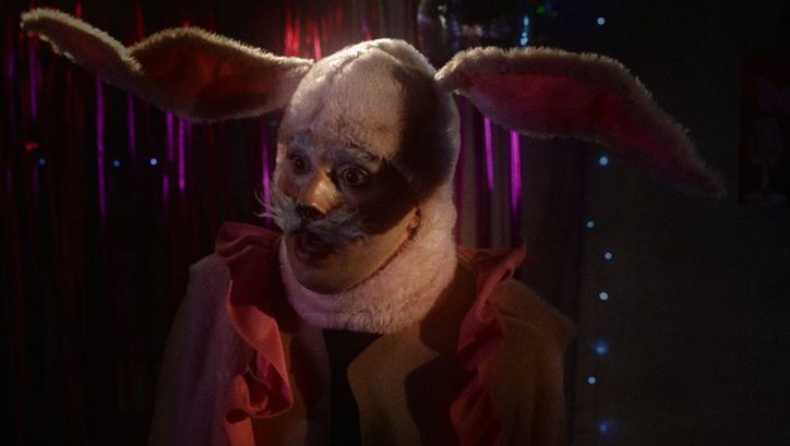 Film still from INFERNINHO: A person in a bunny costume.