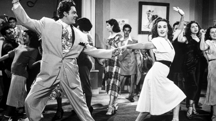 Film still from EL SUAVECITO: A dancing couple at a party.