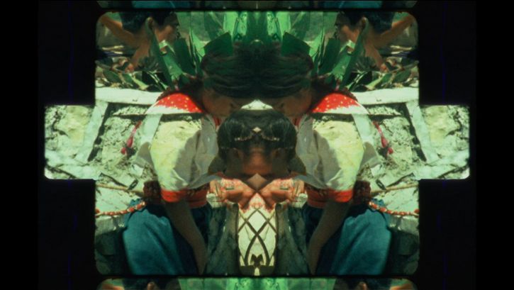 Film still from SENSEMAYA: A kaleidoscopic picture of people in traditional costumes.