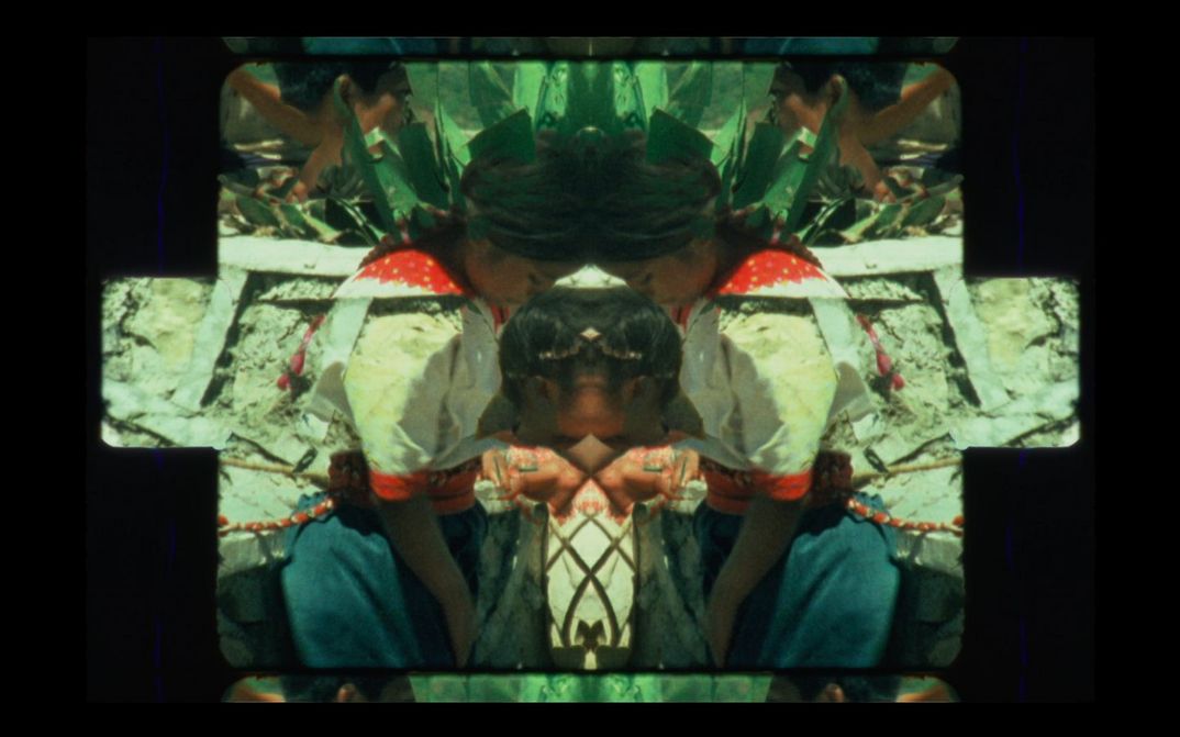 Film still from SENSEMAYA: A kaleidoscopic picture of people in traditional costumes.