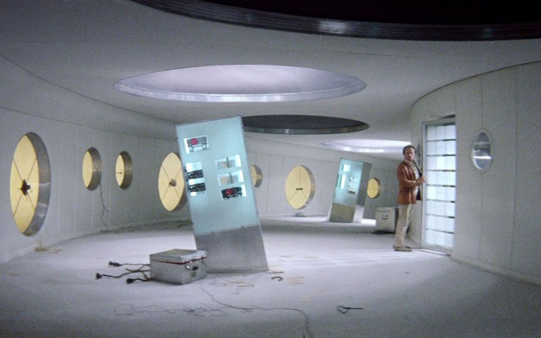 Film still from SOLARIS: A man in normal clothes in a space station.
