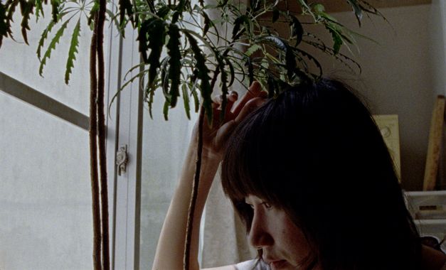 Film still from UNDERGROUND by Kaori Oda. It shows a close-up of a person