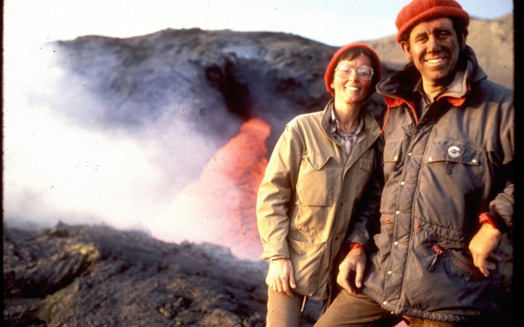 Film still from THE FIRE WITHIN: Maurice and Katja Krafft in front of a volcano.