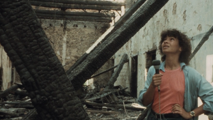 Film still from BEIRUT MY CITY: A young woman with a microphone in her hand stands in a destroyed house.