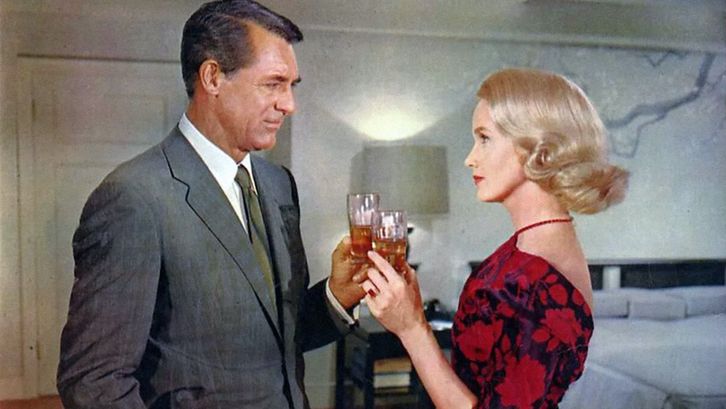 Film still from NORTH BY NORTHWEST: A man and a woman, both elegantly dressed, toast each other.