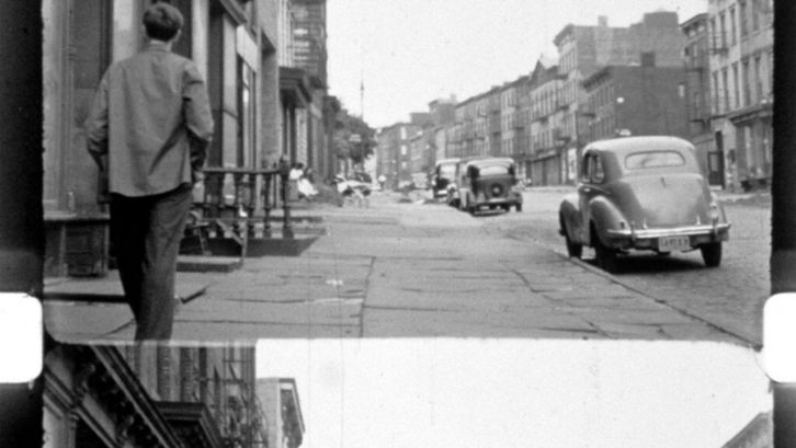 Film still from LOST LOST LOST: You can see a filmstrip with image line and perforation; on the film image a street scene from New York.