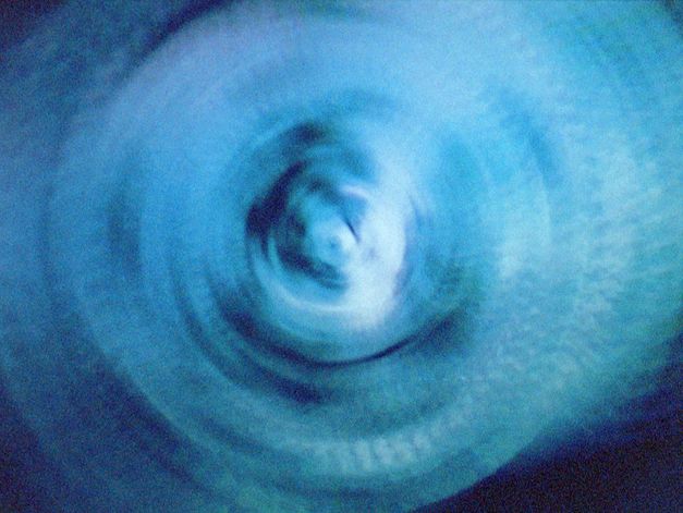 Still from the film "vs" by Lydia Nsiah. Abstract spiral in blue color.