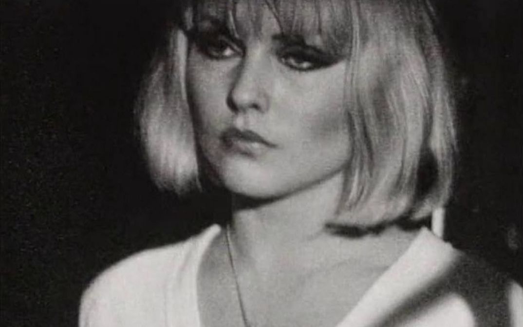 Film still from THE BLANK GENERATION: A woman with a short blonde bob, black eye make-up and a white shirt.