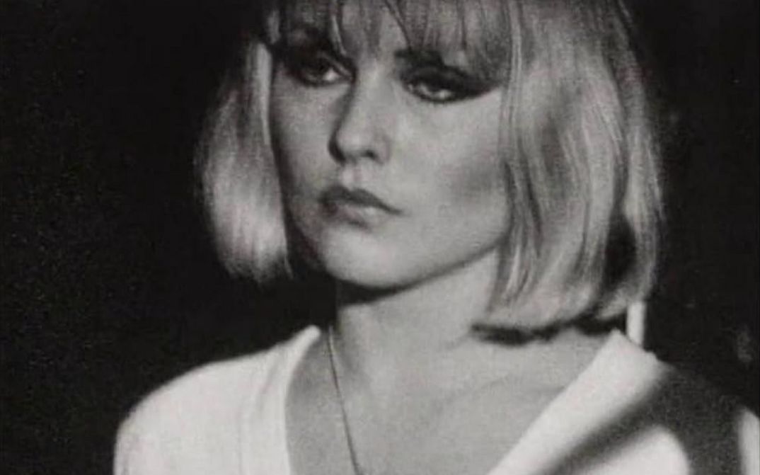 Film still from THE BLANK GENERATION: A woman with a short blonde bob, black eye make-up and a white shirt.