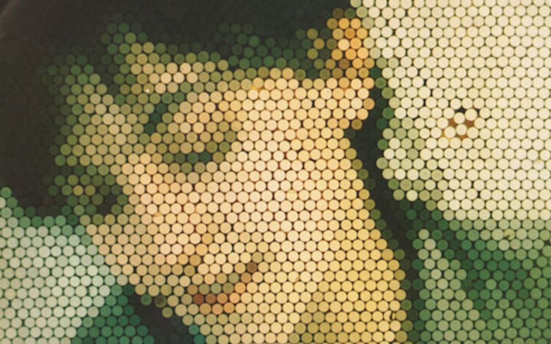 Film still from ECHTZEIT: A heavily pixelated portrait of a woman.
