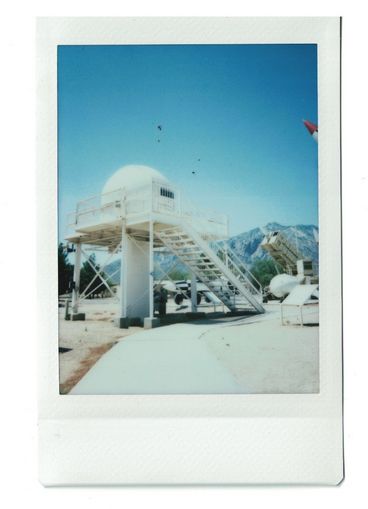 Polaroid of an observation dome inside of an open-air museum.