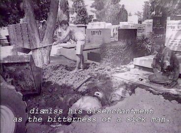 Still from the film "Normality 1–X" by Hito Steyerl. Men dig a grave on a jewish cemetery. 