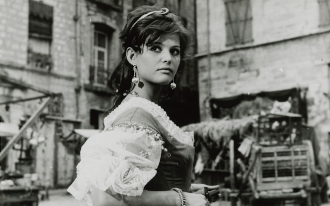Film still from CARTOUCHE: Claudia Cardinale in a street scene in a historical costume.