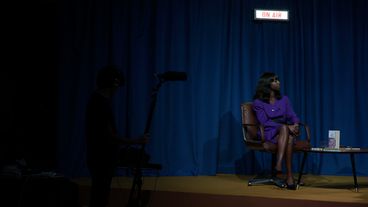 Woman sitting on a talk show stage