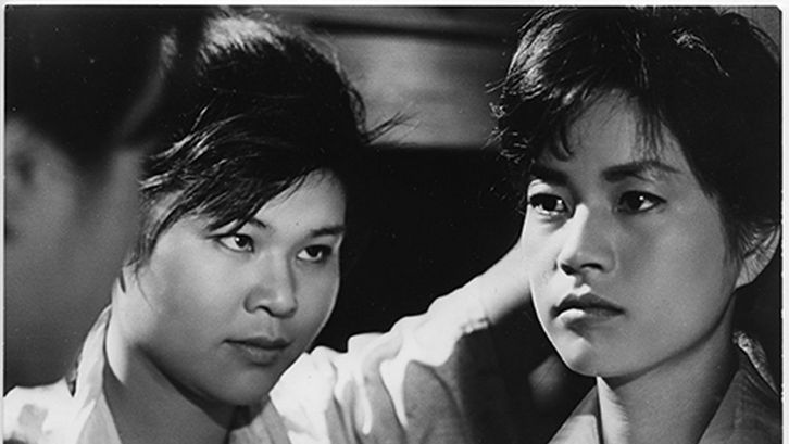 Film still from ONNA BAKARI NO YORU: Three people looking at each other.