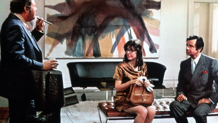 Film still from A NEW LEAF: A woman and two men are sitting in a smart office.