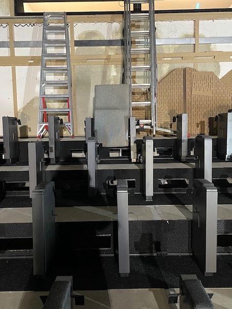 Bild der Baustelle des Kinosaals, ein erster Kinosessel ist eingebaut.