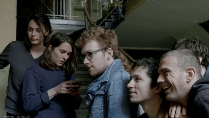 Film still from LE CONCOURS: A group of young people in a staircase.