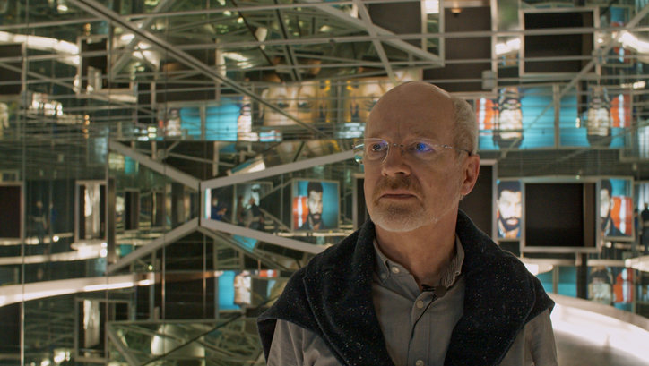Film still from LOST AND FOUND. Martin Koerber in front of an exhibition at the Film Museum.