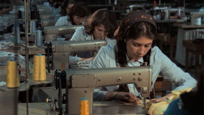  Film still from KARA KAFA: A row of sewing machines with seamstresses.