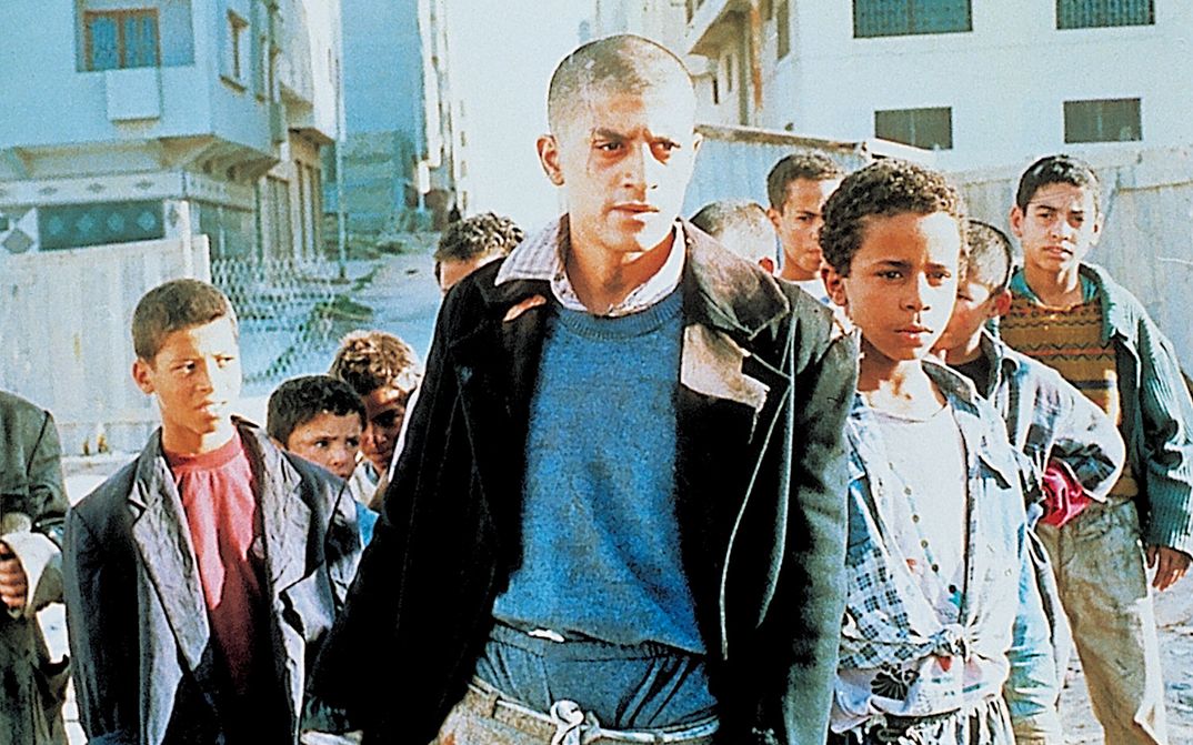 Film still from ALI ZAOUA: PRINCE OF THE STREETS: A group of youths and children on the street.