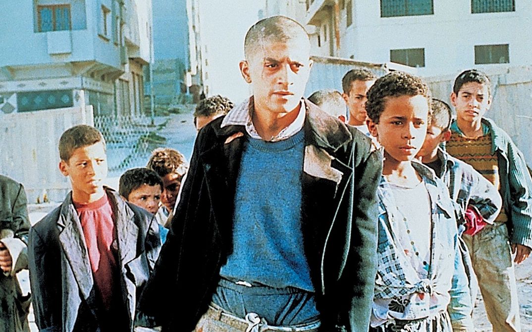 Film still from ALI ZAOUA: PRINCE OF THE STREETS: A group of youths and children on the street.