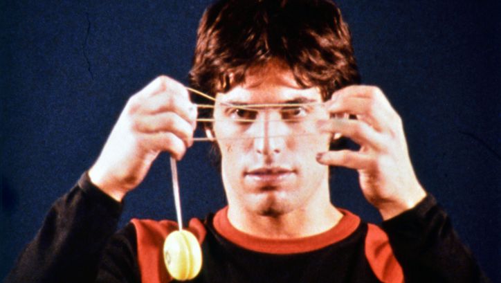Film still from 33 Yoyo Tricks: A man is holding a yoyo in front of his face.