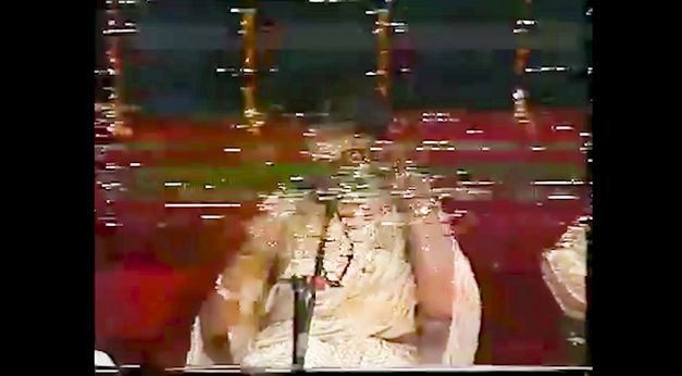 Still from the film "If From Every Tongue It Drips" by Sharlene Bamboat. A pixelated image of a person.