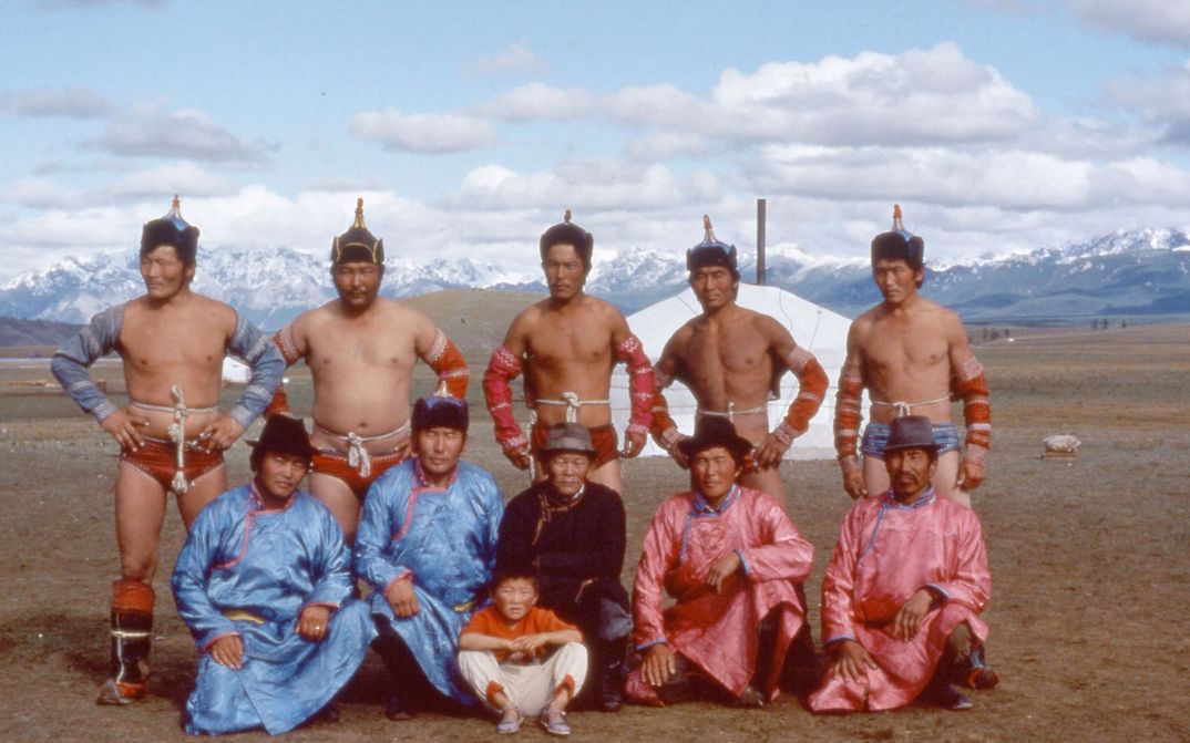 Film still from TAIGA: A group of Mongolian men in traditional costumes pose for the camera.