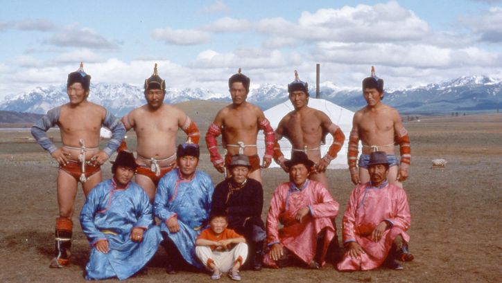 Film still from TAIGA: A group of Mongolian men in traditional costumes pose for the camera.