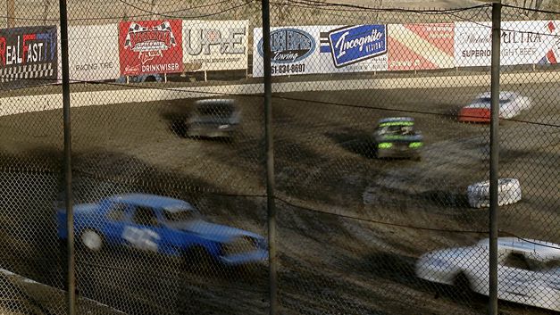 Still from the film"The Unites States of America" by James Benning: You can see cars on a race track, sliding in a curve on muddy ground